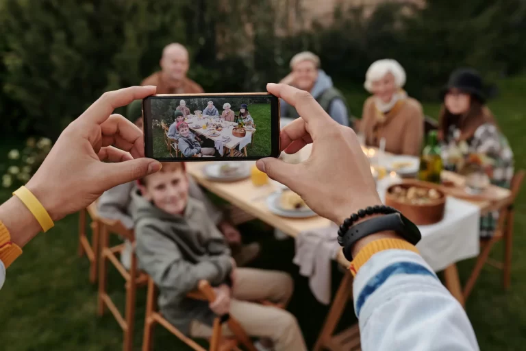 AI and Photography: smartphone photographer capturing a real family moment outdoors