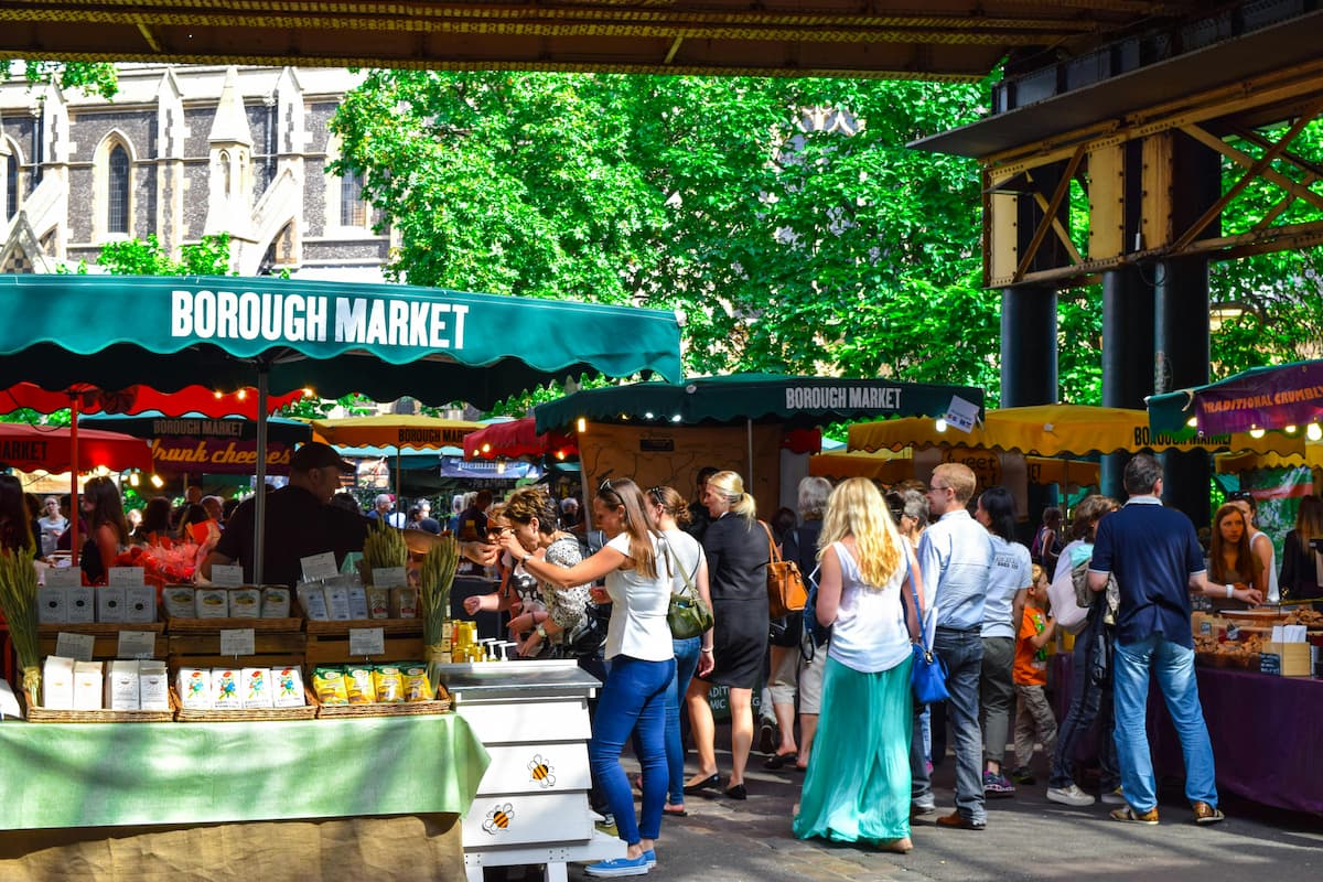 How to simplify a photo in a busy market scene with people, stalls, and overlapping details